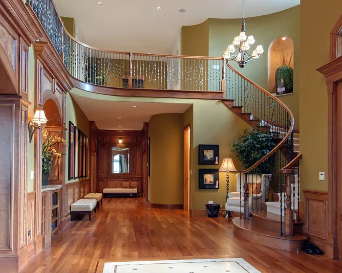 A foyer where wood stairs meet hardwood floors