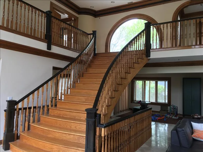 Curved hardwood staircase and matching railings