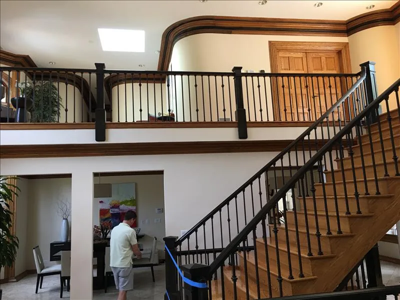 Wood handrails and dark spindles around a staircase