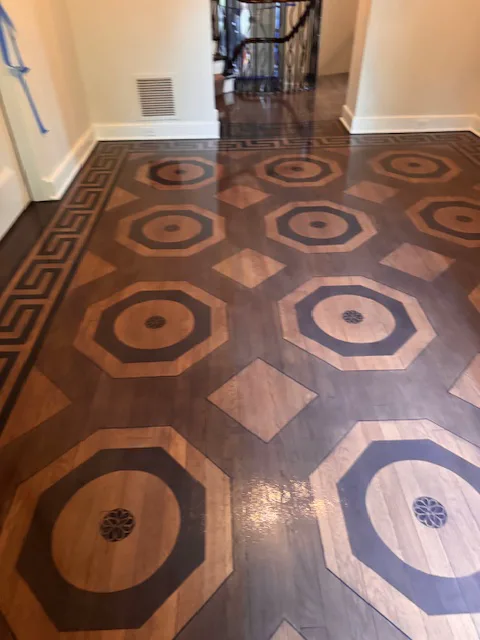 Custom wood inlay floor with a Greek key border