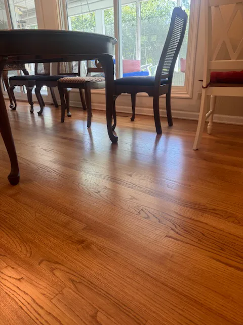 Refinished oak floor under a dining table