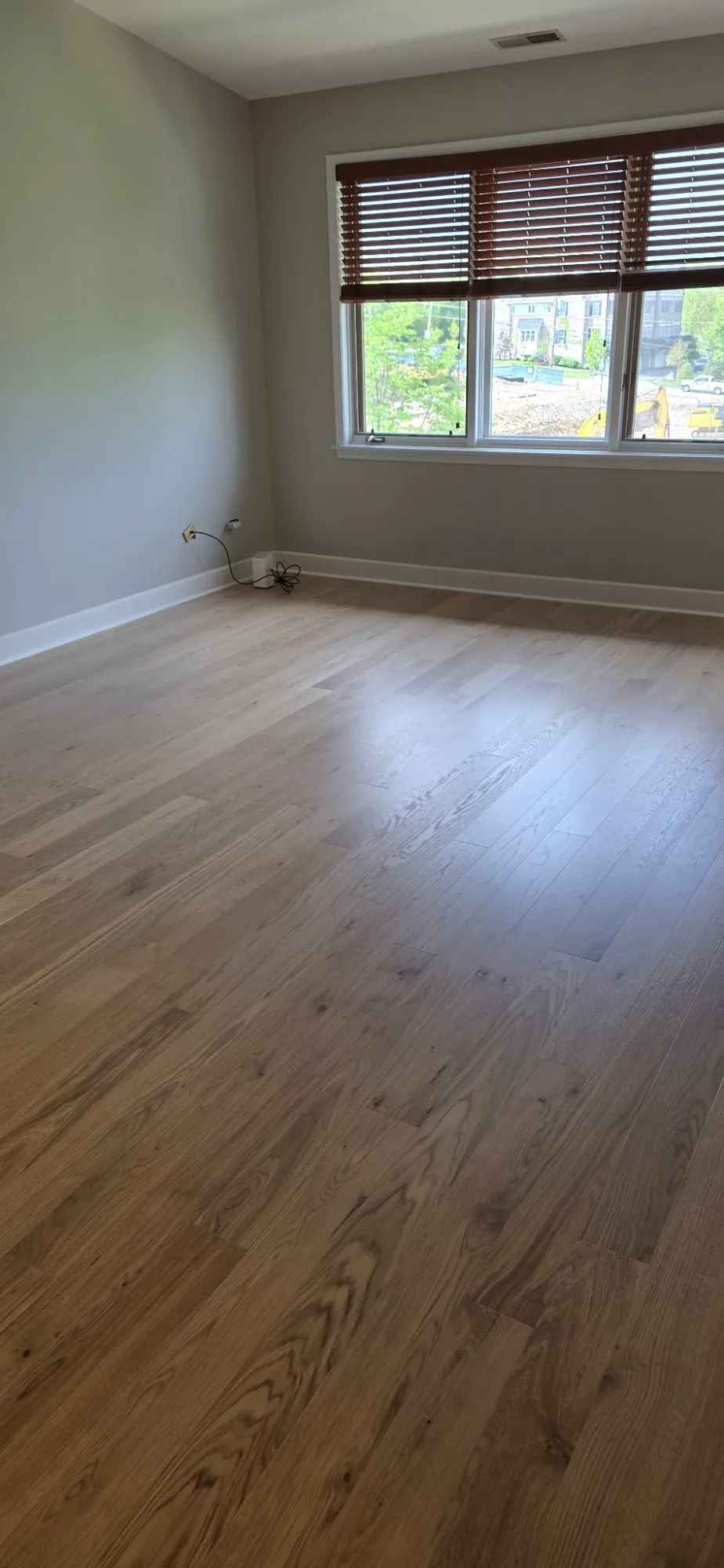 Wide-plank oak flooring in a bedroom